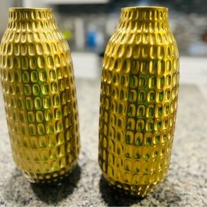 Gold decorative vase and decorative floral arrangement.